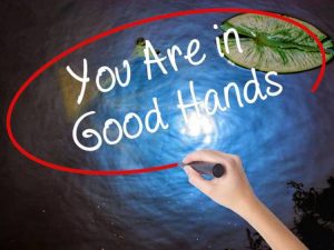 67815030-woman-hand-writing-you-are-in-good-hands-with-marker-over-transparent-board-isolated-on-nature-busin